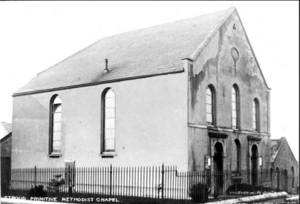 A black and white picture of a small chapel